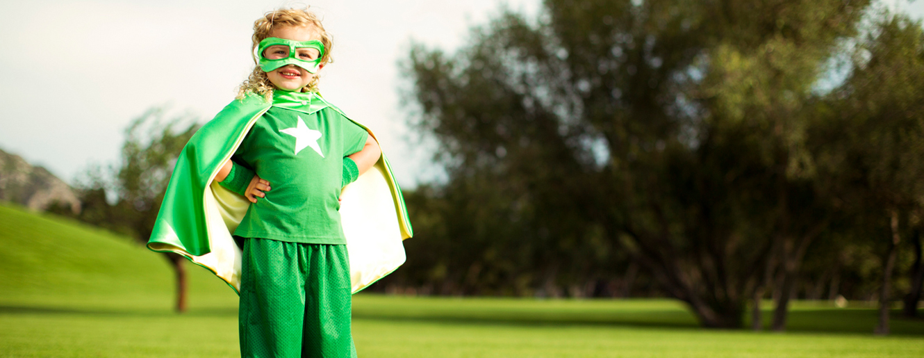 Little girl dressed in super hero/cape costume